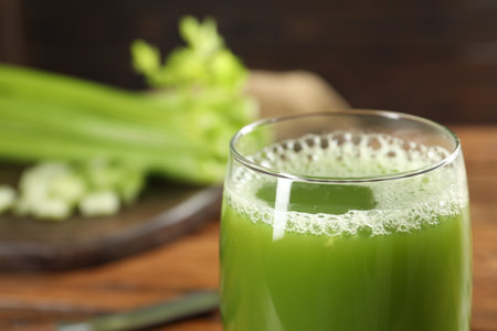 Glass of fresh celery juice against blurred background, closeup. Space for textの写真素材