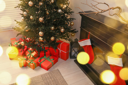Beautifully wrapped gift boxes under Christmas tree in room, above viewの写真素材