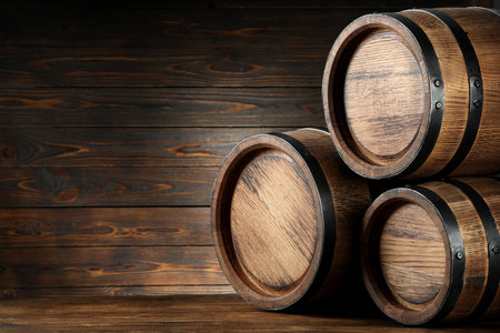 Wooden barrels on table, space for text