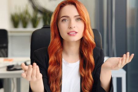 Woman having video call in office, view from web cameraの写真素材