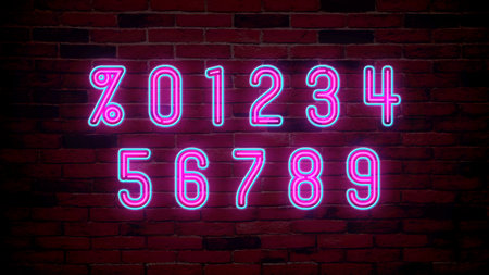 Glowing neon number and percent signs on brick wallの写真素材