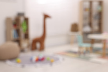 Stylish kindergarten interior with toys and modern furniture, blurred viewの写真素材