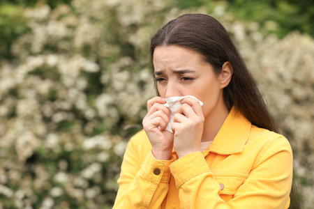 Woman suffering from seasonal spring allergy outdoorsの写真素材