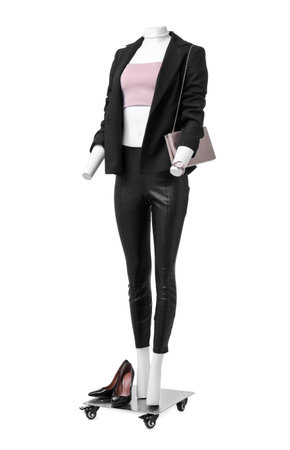 Female mannequin dressed in black suit and crop top with accessories isolated on white. Stylish outfitの写真素材