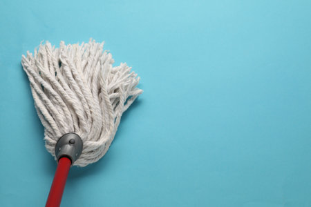 Mop with plastic handle on light blue background, top view. Space for textの写真素材