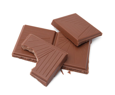 Broken milk chocolate bar on white backgroundの写真素材
