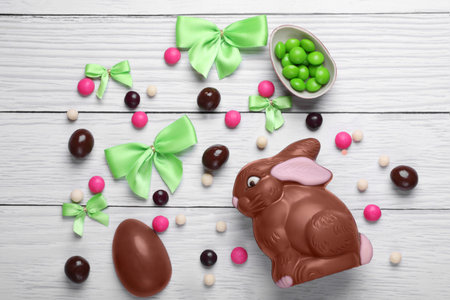 Flat lay composition with chocolate bunny on white wooden table. Easter celebrationの写真素材