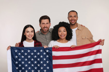 4th of July - Independence Day of USA. Happy friends with American flag on white backgroundの写真素材