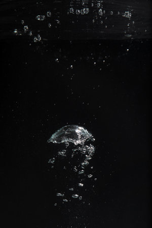 Air bubbles in water on black background