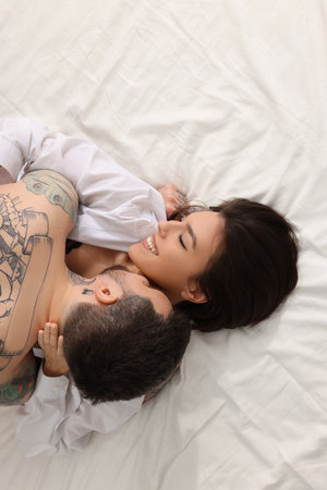 Passionate couple having sex on bed, top viewの写真素材