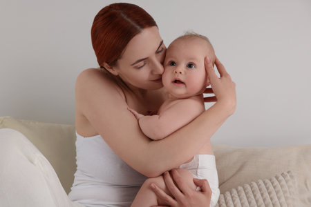Mother with her newborn baby at homeの写真素材