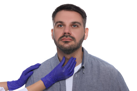 Endocrinologist examining thyroid gland of patient on white background, closeupの写真素材