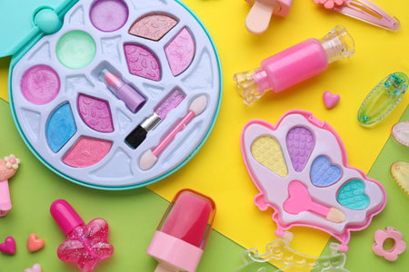 Eye shadow palette and other decorative cosmetics for kids on color background, flat layの写真素材