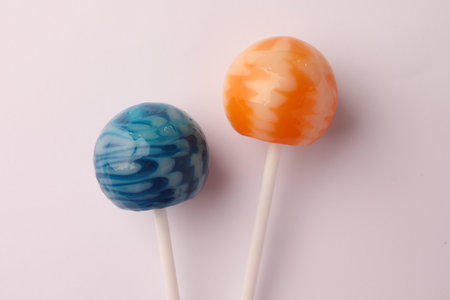 Tasty lollipops on white background, flat lay