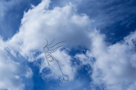 Imagination and creativity. Fluffy cloud resembling mermaid in blue sky, drawn outlineの写真素材