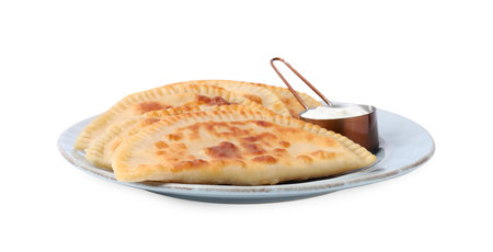 Delicious fried chebureki with cheese and sauce isolated on whiteの写真素材
