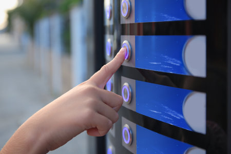 Using coffee vending machine. Woman pressing button to choose drink, closeupの写真素材