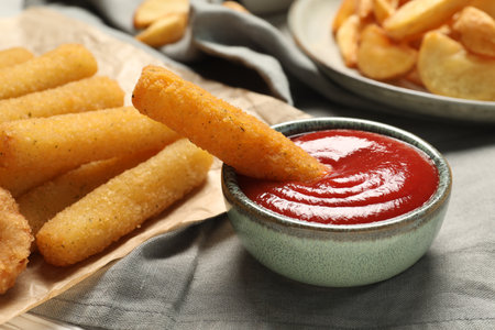 Delicious cheese sticks and ketchup on table, closeupの写真素材