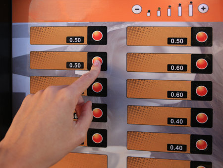 Using coffee vending machine. Woman pressing button to choose drink, closeupの写真素材