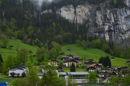 Picturesque view of village and forest in high mountainsの写真素材