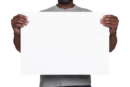 African American man holding sheet of paper on white background, closeup. Mockup for designの写真素材
