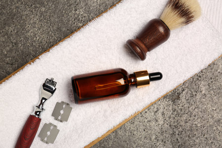 Tray with shaving accessories for men and towel on gray table, top viewの写真素材