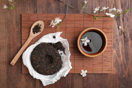 Flat lay composition with aromatic pu-erh tea on wooden tableの写真素材