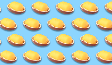 Mykolaiv, Ukraine - June 26, 2023: Half of Kinder Surprise Egg and plastic capsule with toy on light blue background, seamless pattern designの写真素材