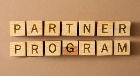 Words Partner Program made of wooden cubes with letters on beige background, top view. Banner designの写真素材