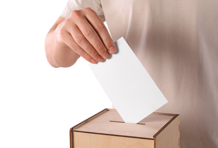 Man putting his vote into ballot box on white background, closeup