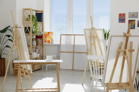Stylish artist's studio interior with easels and canvases. Creative hobbyの写真素材