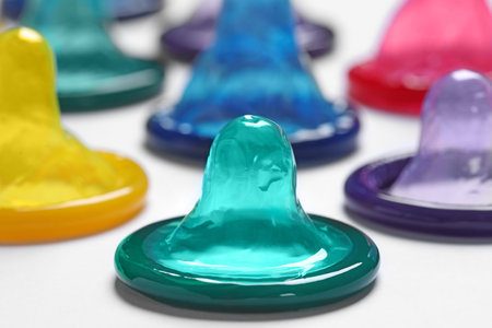 Colorful condoms on white background, closeup. Safe sexの写真素材