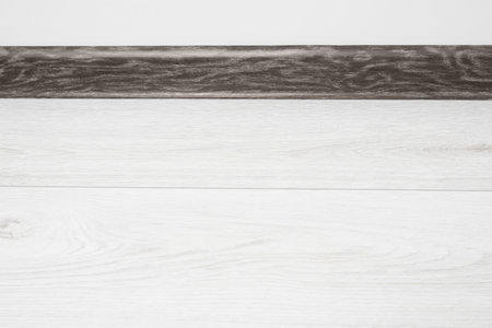 Black wooden plinth on laminated floor near white wall indoorsの写真素材