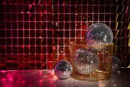 Many shiny disco balls on floor near foil party curtain. Space for textの写真素材