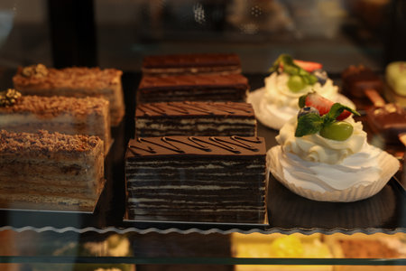 Different tasty desserts on counter in bakery shop, closeupの写真素材