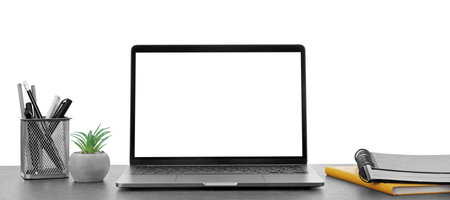 Computer, potted plant and stationery on table against white background. Stylish workplaceの写真素材