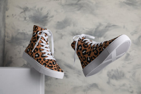 Stylish presentation of classic old school sneakers on gray background