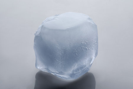 One crystal clear ice cube isolated on white