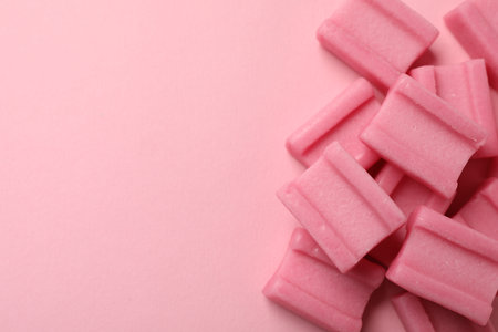 Tasty chewing gums on pink background, flat lay. Space for textの写真素材