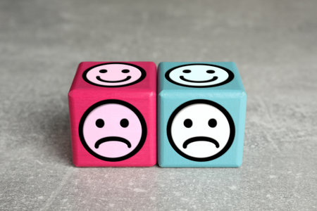 Complaint. Pink and light blue wooden cubes with sad and happy on different sidesの写真素材