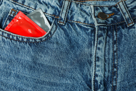 Packaged condoms in jeans pocket, closeup. Safe sexの写真素材