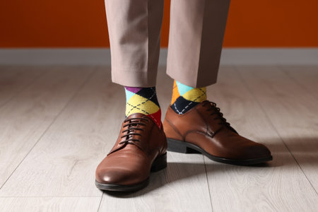 Man wearing stylish shoes and colorful socks indoors, closeupの写真素材