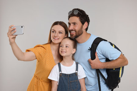 Happy family taking selfie on light grey backgroundの写真素材