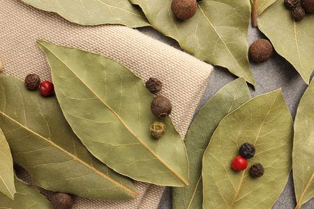 Aromatic bay leaves and spices on light gray table, flat layの写真素材