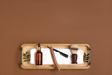 Set of men's shaving tools on brown background, top view. Space for textの写真素材