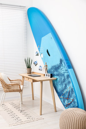 SUP board and workplace in room. Interior designの写真素材