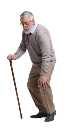 Tired senior man with walking cane on white backgroundの写真素材