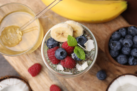 Tasty chia matcha smoothie with fruits and mint on wooden table, flat lay. Healthy breakfastの写真素材