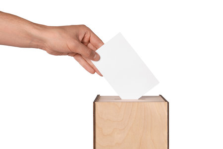 Man putting his vote into ballot box on white background, closeupの写真素材