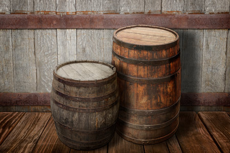 Wooden barrels on brown surface near textured wall